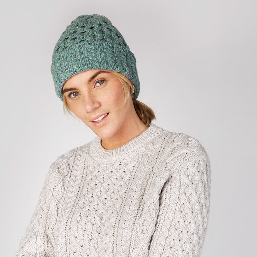 Woman in ocean mist beanie and cable knit sweater