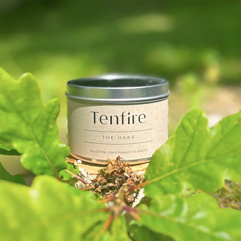 Candle in a tin with leaves.