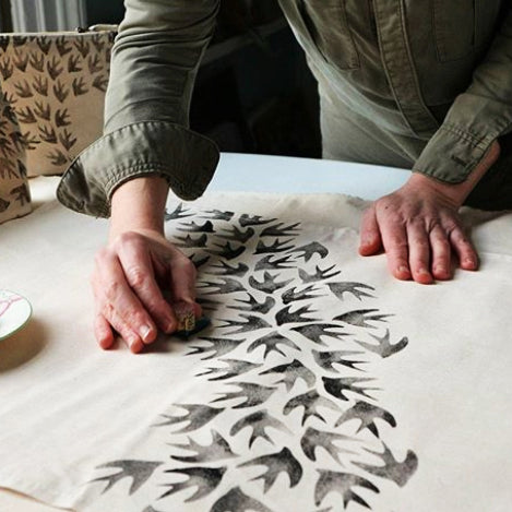 Fawn teatowel being printed with bird pattern.