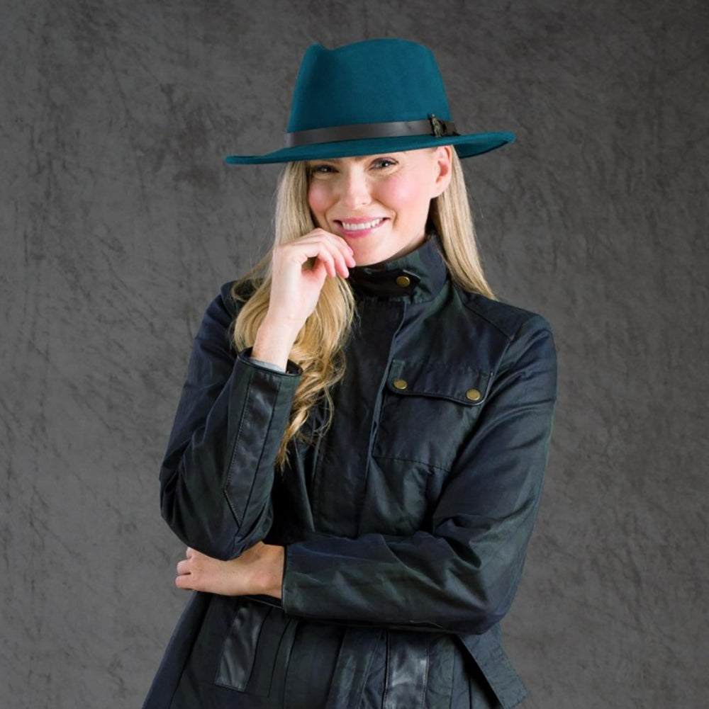 Woman wearing teal Boston hat