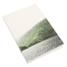 Mountain lake landscape on a square notebook.
