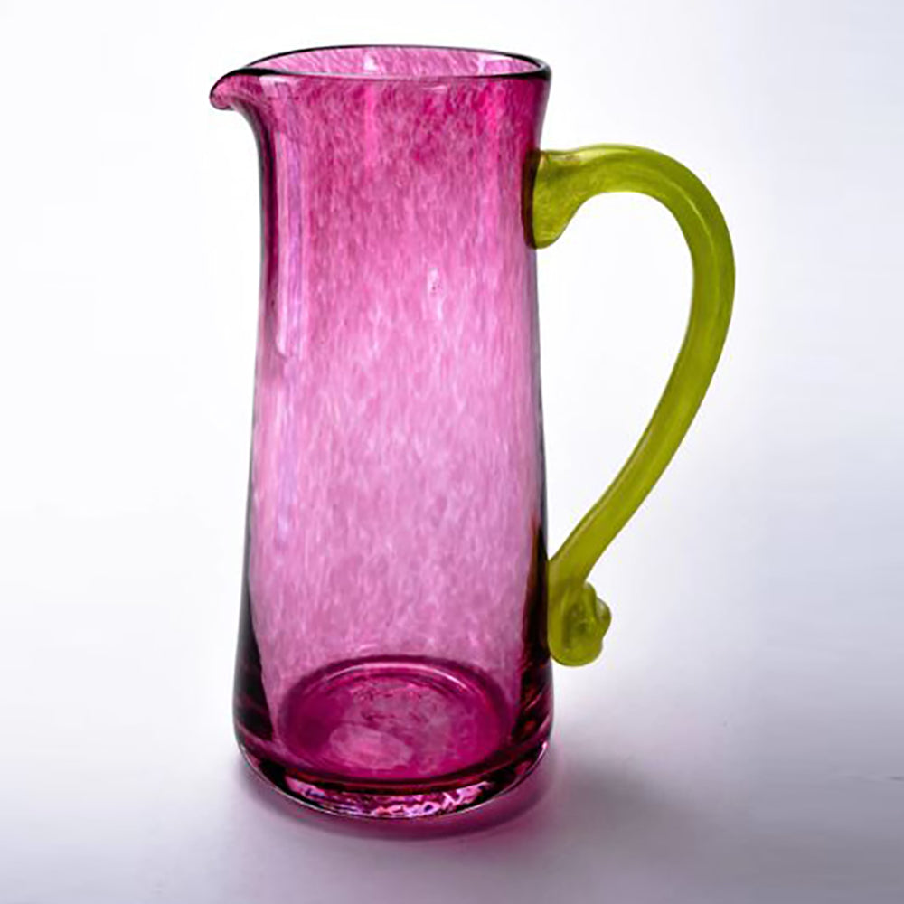 pink glass jug with green handle