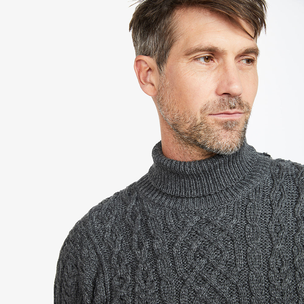 Man in grey polo neck aran sweater