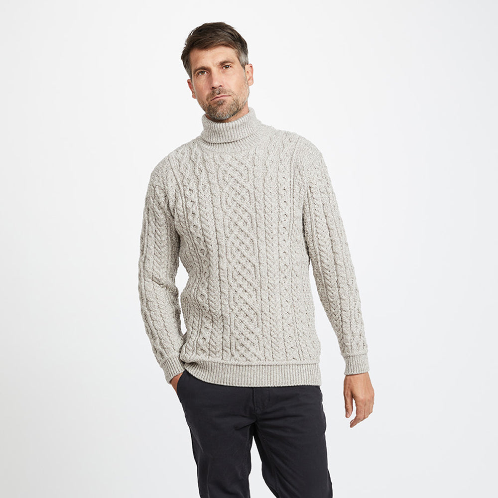 Man in cream Aran polo neck sweater