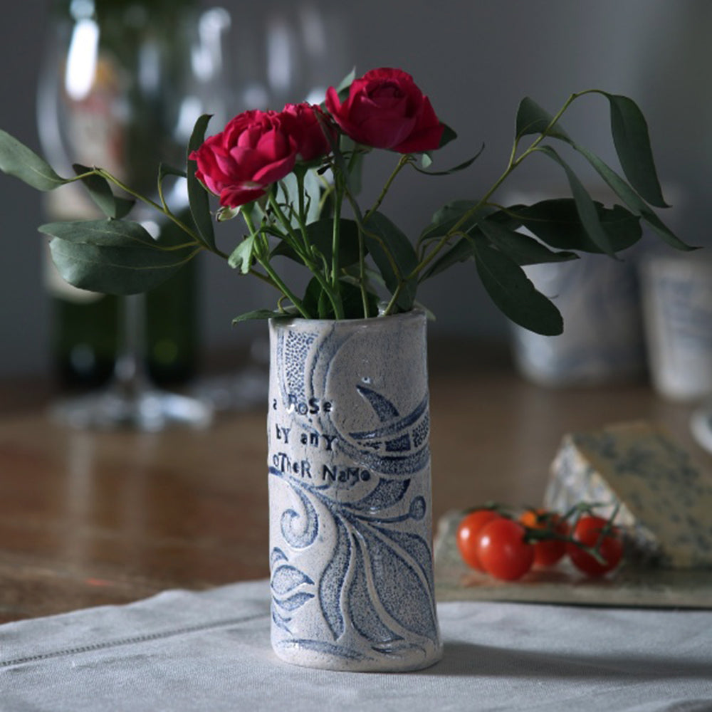 Small blue rose vase with red roses