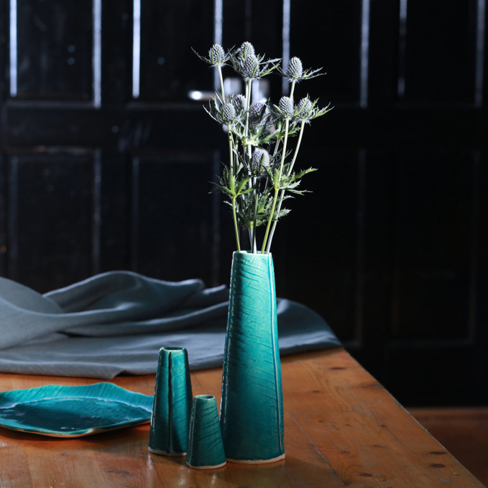 Teal vase lifestyle shot with thistle flowers
