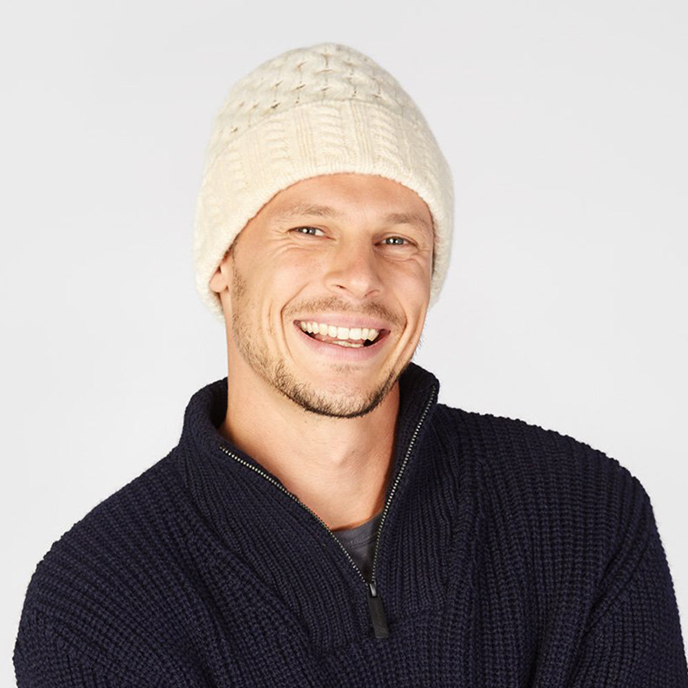 Man wearing a white square beanie.