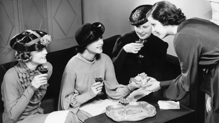 Women socializing together in vintage clothing 