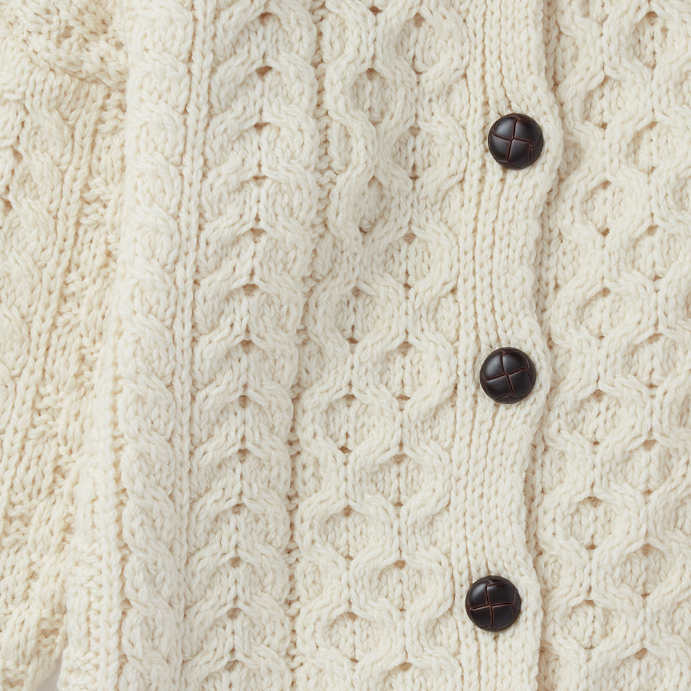 Cream Aran cardigan with buttons, front view.