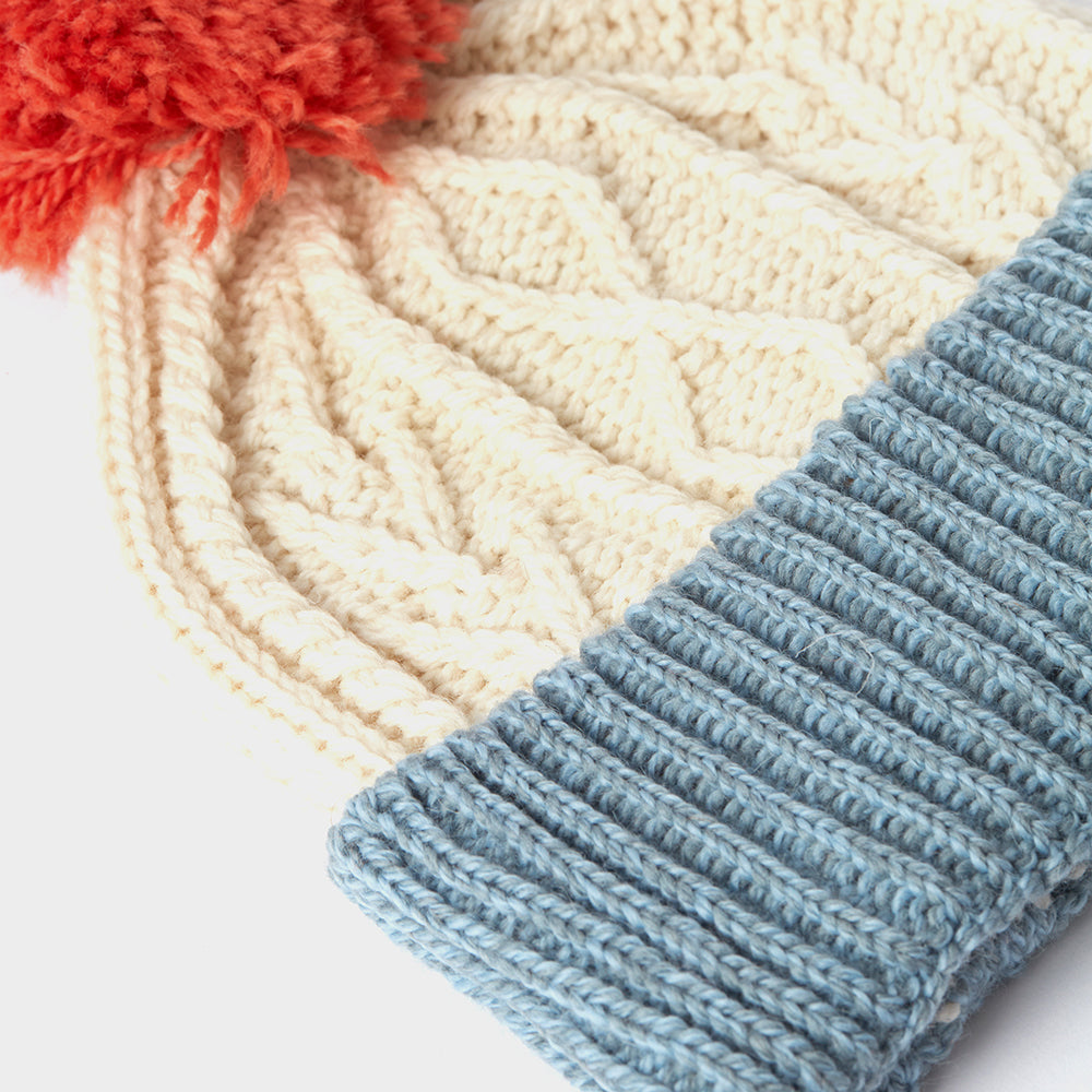Cream and blue kids Aran wool pom pom hat closeup