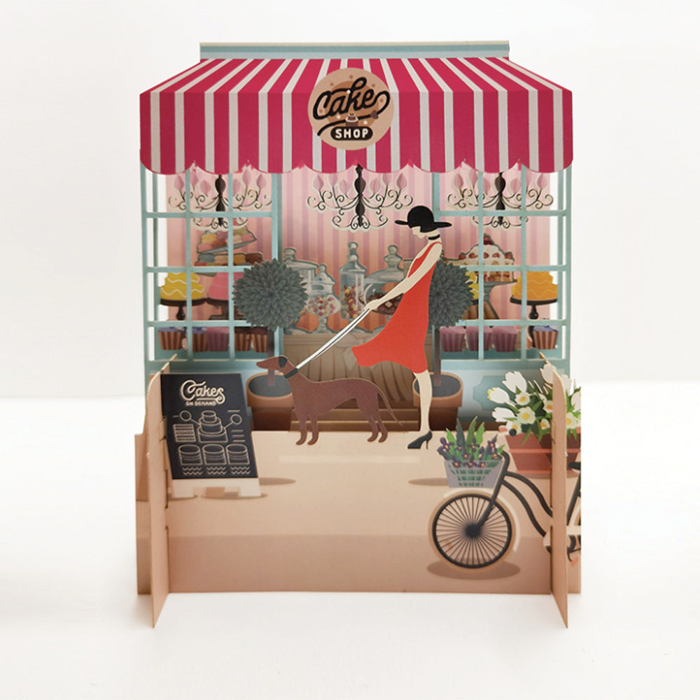 IDH Cake Shop illustration of a woman with dog and cake display.