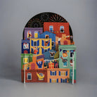Pop-up cityscape with celebrating figures & fireworks.