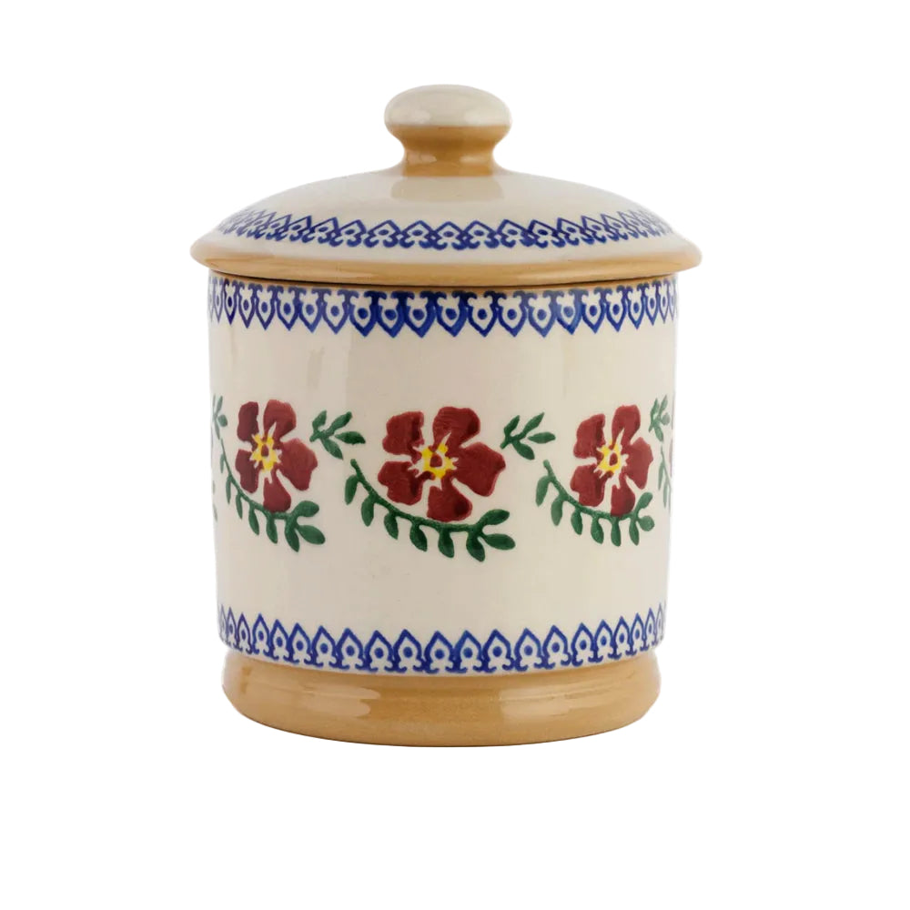 Ceramic jar with floral design and blue decorative patterns on a white background
