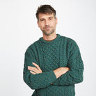 Man in green cable-knit sweater