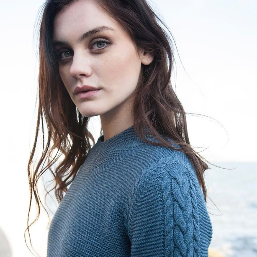 Ashbrooke closeup of woman in blue sweater.