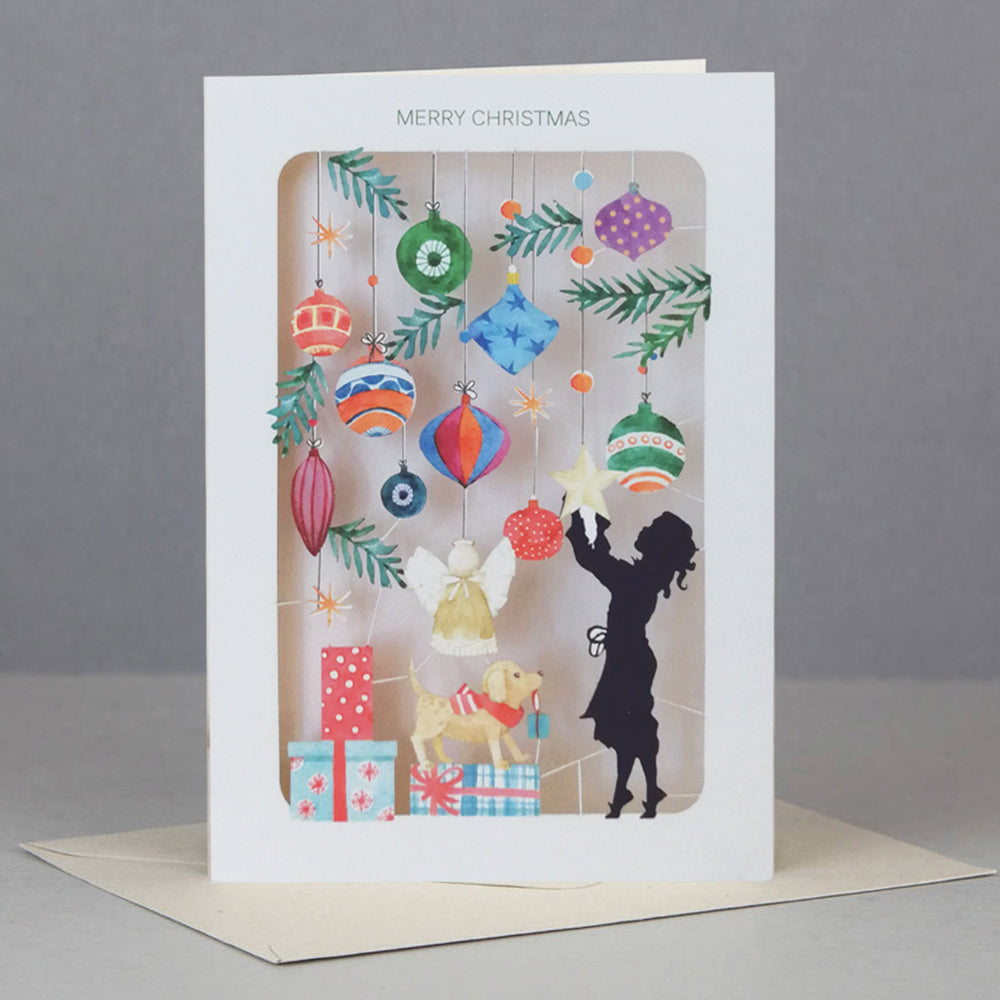 Christmas card with hanging ornaments and silhouette
