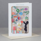 Christmas card with hanging ornaments and silhouette