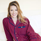 Woman in pj3 red plaid pajamas smiling