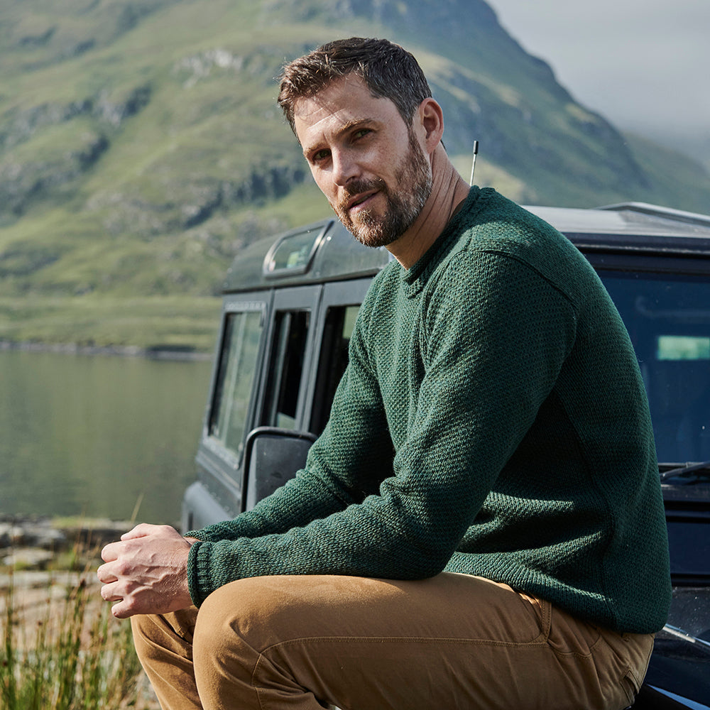 Man wearing green roll neck sweater