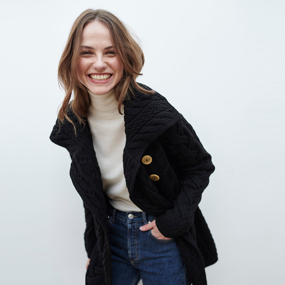 Woman wearing black buttoned longline cardigan