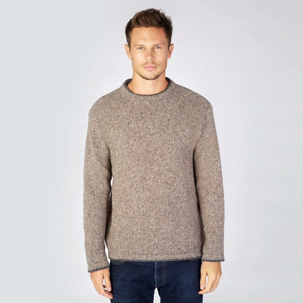 Man in Roundstone sweater on rocky ground
