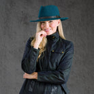 Woman wearing teal Boston hat