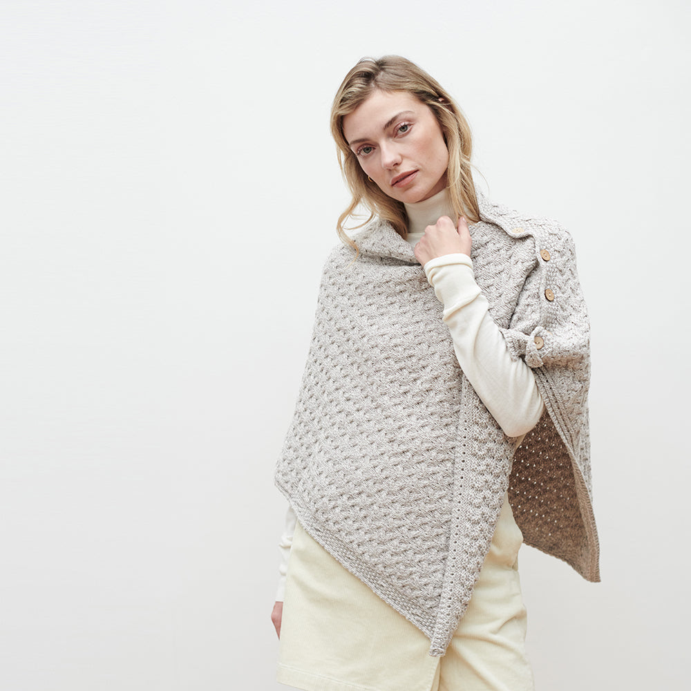 Woman wearing square buttoned cape shrug