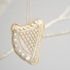 Square harp ornament with gold and pearl details