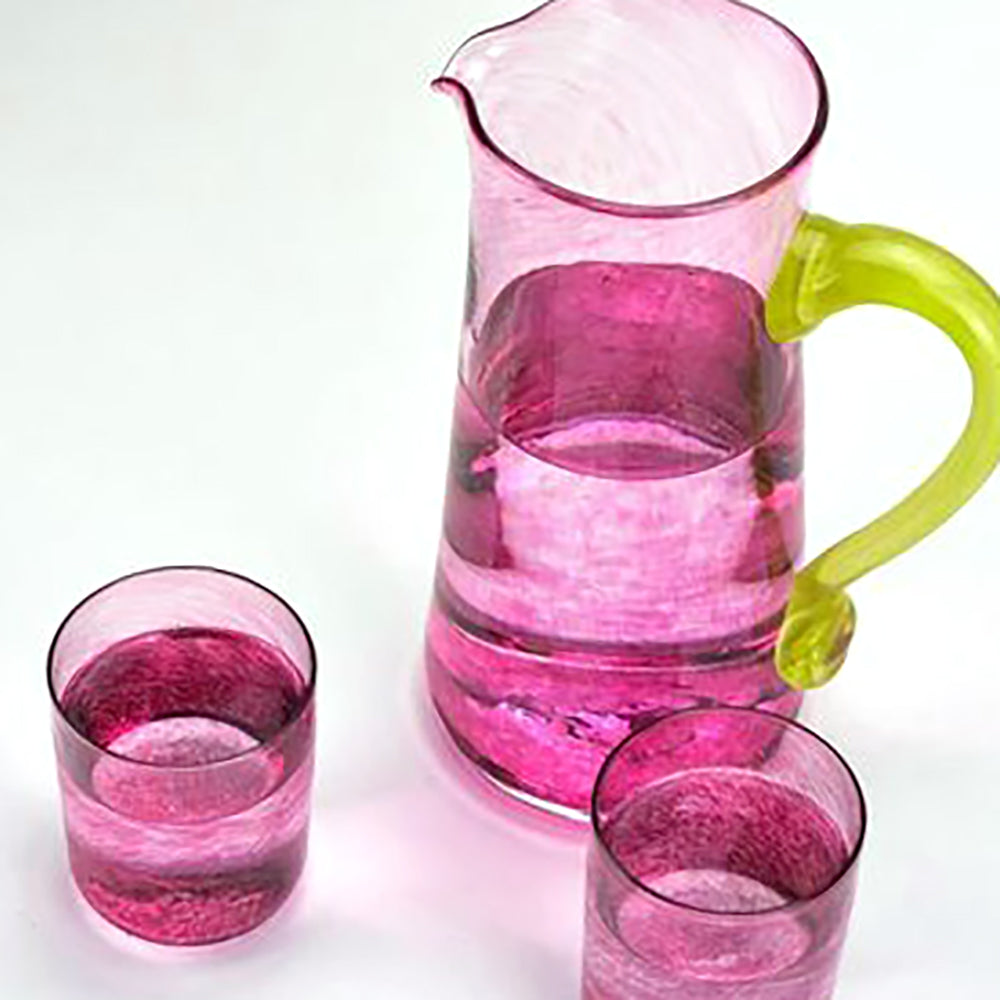 pink glass jug with green handle and pink glass drinking glasses