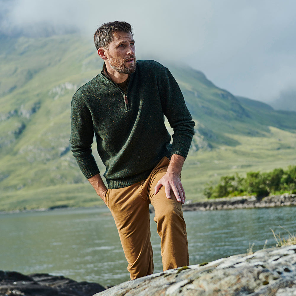 Man in green Troyer zip sweater