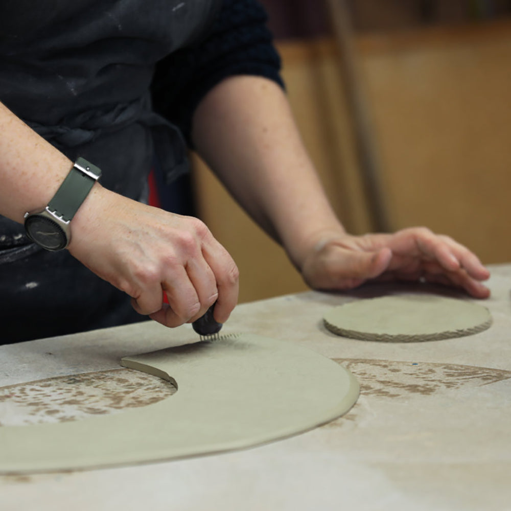 Sarah McKenna making pottery, working with clay.
