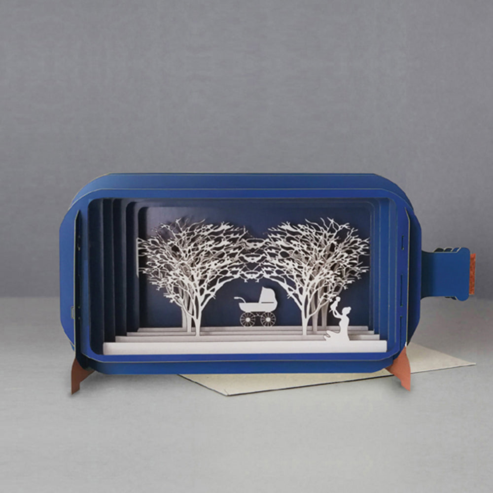 Blue papercraft baby pram scene
