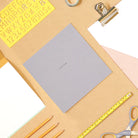 Square grey notebook on a lifestyle desk