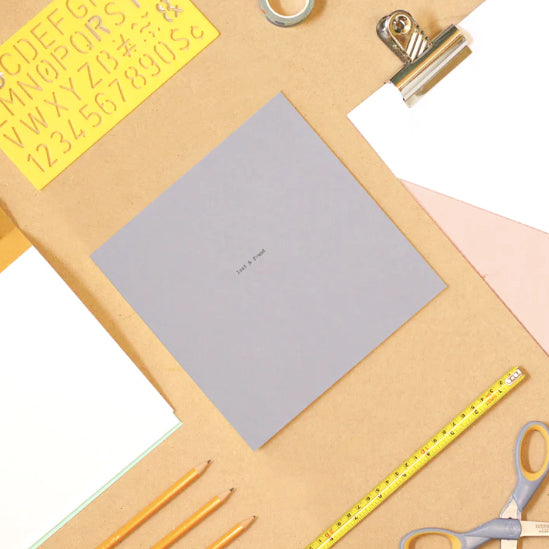 Square grey notebook on a lifestyle desk