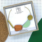 multi shape wooden necklace in colour sage green and wood. 