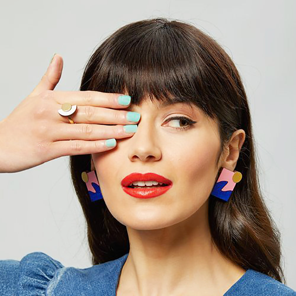 pink blue and gold statement stud on model
