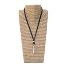 Steel bar pendant necklace on display.